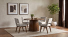 CoasterEveryday Galindo 52-inch round walnut veneer dining table with a smooth, polished wood surface and sturdy wooden legs.