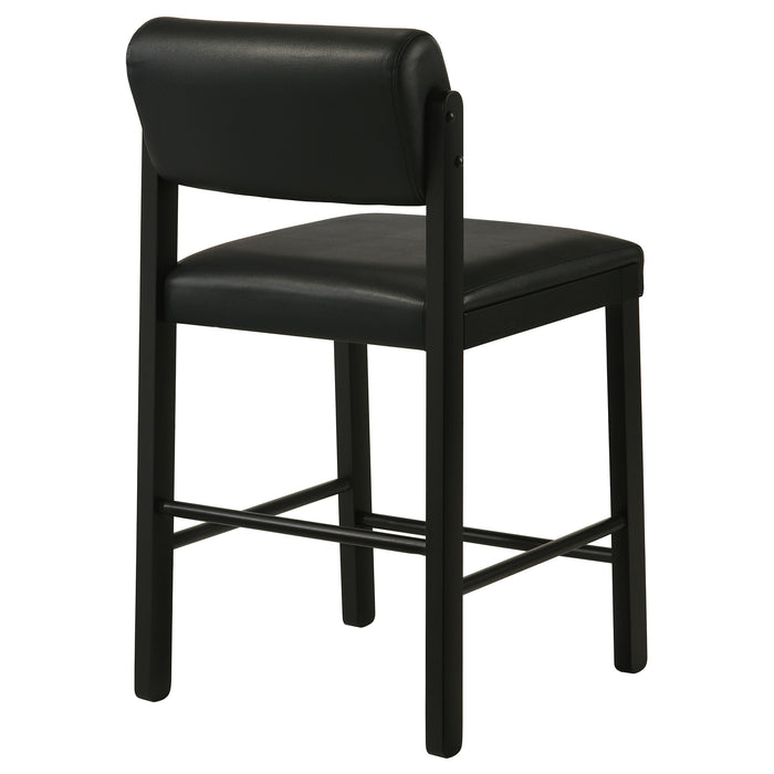 Set of two black Kehoe upholstered counter height chairs by CoasterEveryday, featuring cushioned seats and wooden legs.