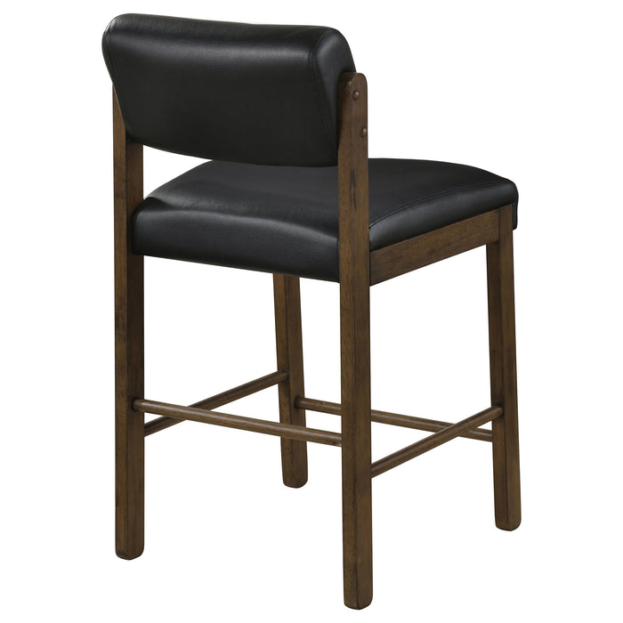 Pair of CoasterEveryday black and walnut upholstered counter height chairs with padded seats and high backs for kitchen or bar seating.