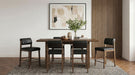 Set of two CoasterEveryday black and walnut upholstered counter height chairs with padded seats and wooden legs.