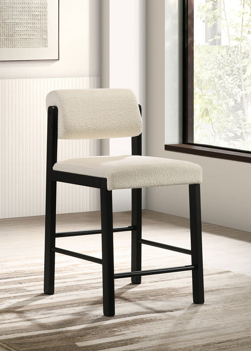 Set of two CoasterEveryday Kehoe upholstered counter height chairs with cream and black fabric, featuring a modern furniture design.