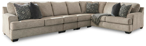 Signature Design by Ashley Bovarian 4-piece stationary sectional sofa with plush cushions and neutral fabric upholstery.