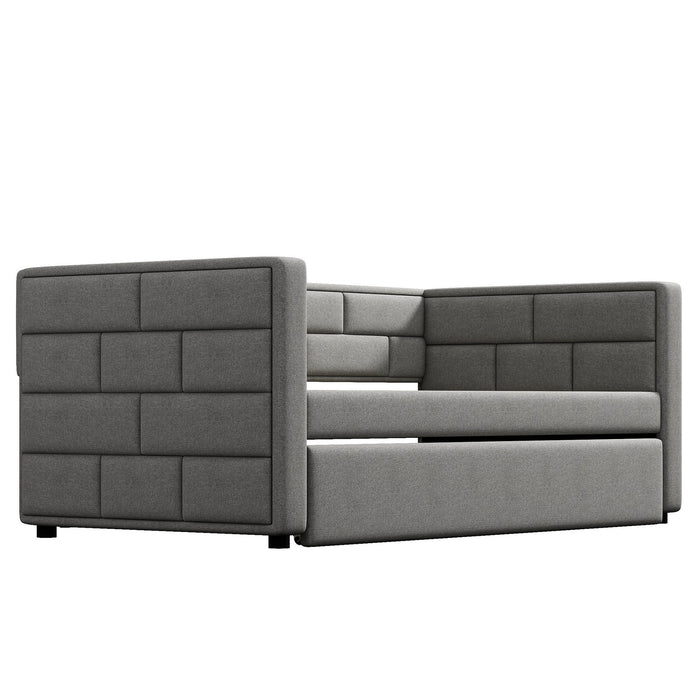 Gray upholstered twin size daybed with padded back and sides, includes trundle bed, by Giga in a modern bedroom setting.