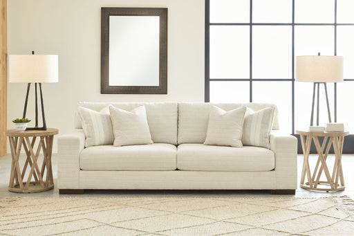 Signature Design by Ashley Maggie stationary sofa in Birch with plush cushions and wide armrests, modern living room furniture.
