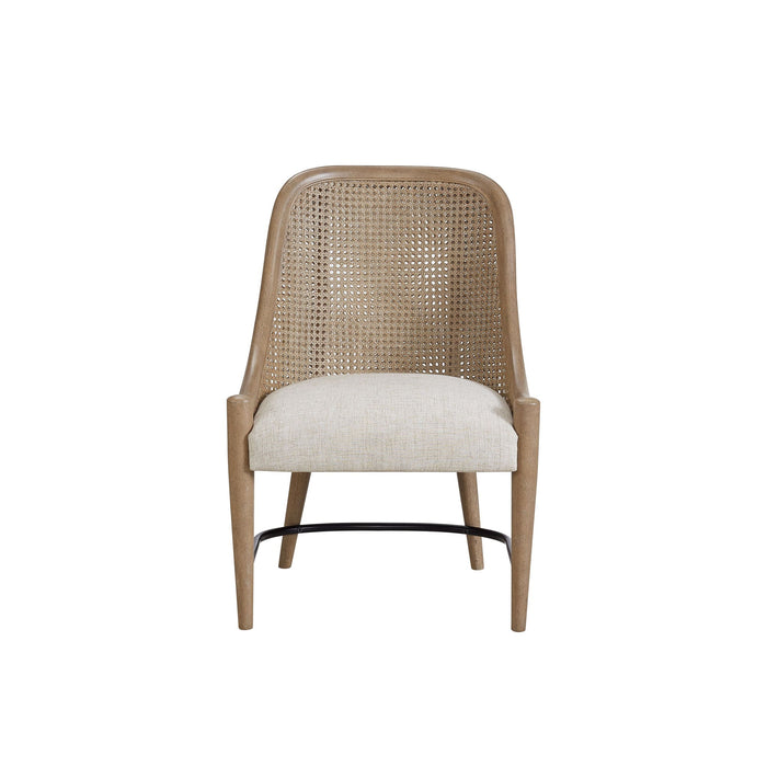 Set of two Bernards Furniture cane-backed host chairs in sand color, featuring wooden legs and woven cane backrests.
