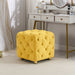 Giga upholstered ottoman with soft cushioning, serving as a small end table, footstool, or dressing chair in living rooms or bedrooms