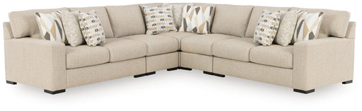 Benchcraft Laurelgrove 5-piece stationary sectional sofa with plush cushions and modern design, shown in a stylish living room setting.