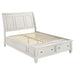 Cream white Sandy Beach Wood Queen Storage Panel Bed by CoasterEssence with a classic panel headboard and spacious storage drawers.