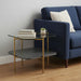 HomeRoots glass and metal square end table with shelf, featuring a gold frame and clear glass top and shelf.