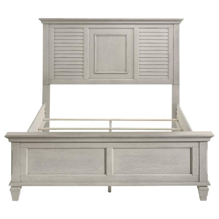 Distressed white Franco Wood Queen Panel Bed from CoasterEssence, showcasing the elegant headboard and classic furniture design.