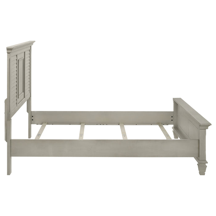 Distressed white Franco Wood Queen Panel Bed by CoasterEssence with a classic wooden design and elegant headboard.