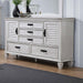 Distressed white Franco 5-drawer dresser by CoasterEssence, showcasing sleek furniture design with metal handles and spacious storage drawers.