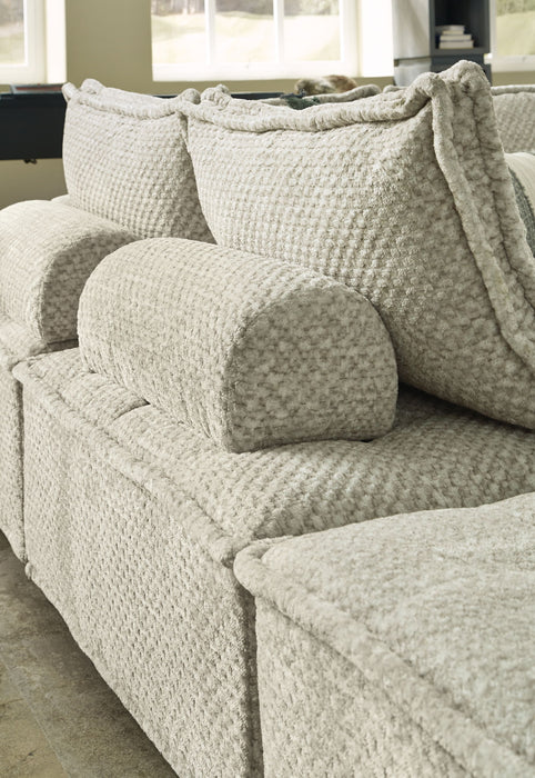 Ashley Furniture Bales stationary sectional sofa with plush cushions and modern design, shown in a spacious living room setting.