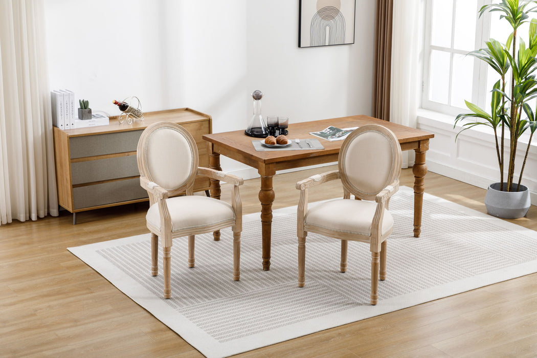 Set of two Giga French vintage upholstered fabric dining armchairs with curved wooden arms and plush cushions.
