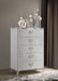 White high gloss Cassia 5-drawer bedroom chest of drawers by CoasterEveryday, showing sleek modern furniture with five spacious drawers.