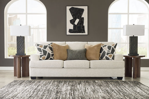 Benchcraft® Heartcort quartz stationary sofa with plush cushions and modern design, shown in a cozy living room setting.