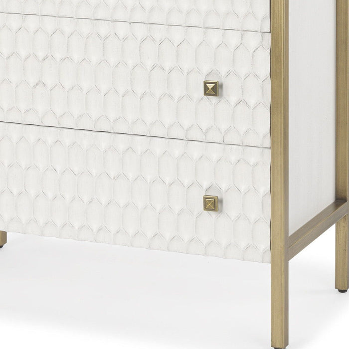 Wood and metal 32-inch accent cabinet with carved geometric design, three drawers, in gold and white from HomeRoots.