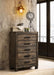 Rustic golden brown Woodmont 5-drawer bedroom chest by CoasterEveryday showing wooden drawers and sturdy construction.