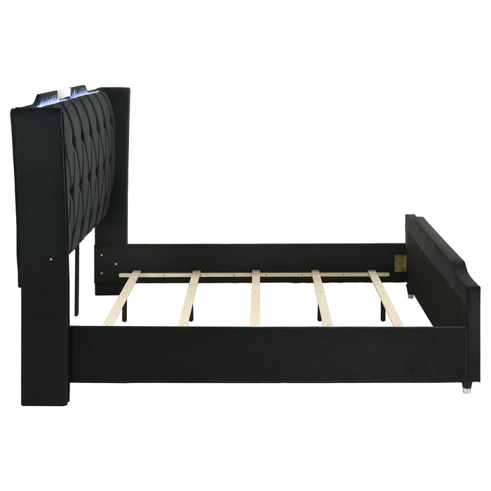 Black California King LED upholstered bed by CoasterEveryday with modern headboard and built-in LED lighting, in a stylish bedroom setting.