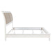 White upholstered Eastern King panel bed with a sleek, modern design and sturdy frame, perfect for a spacious bedroom.