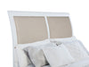 White upholstered Bexhill 56-inch queen panel bed with a modern furniture design, featuring a padded headboard and sleek frame.