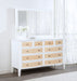 White Bexhill 10-drawer dresser with matching mirror, made of wood with sleek handles and a spacious top surface.