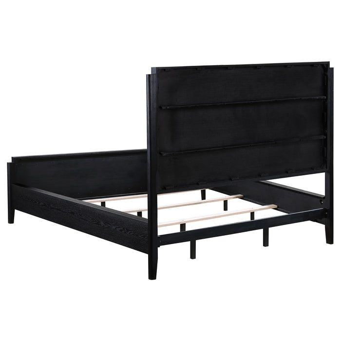 Black upholstered California king bed from Brookmead, featuring a modern furniture design with a tall headboard.