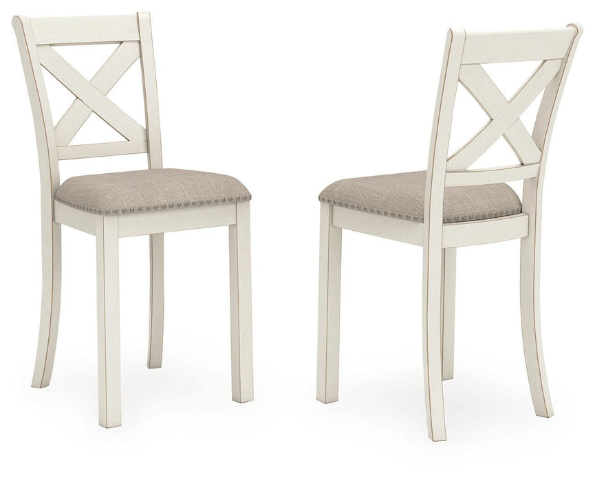 Set of two Robbinsdale upholstered barstools by Signature Design in antique white with cushioned seats and wooden legs.