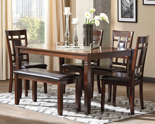 Six-piece brown dining room table set by Signature Design by Ashley, featuring a spacious table with matching chairs.