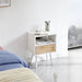 Modern rattan nightstand with power outlet, USB ports, drawer, and solid wood legs, ideal for living room or bedroom.