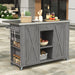 Giga outdoor kitchen island with stainless steel top, ample storage, towel and spice racks, and bottle opener in a backyard setting.