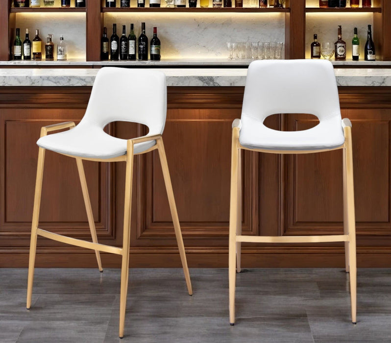 Set of two white faux leather and steel low back bar chairs with gold accents by HomeRoots, perfect for modern bar or kitchen.