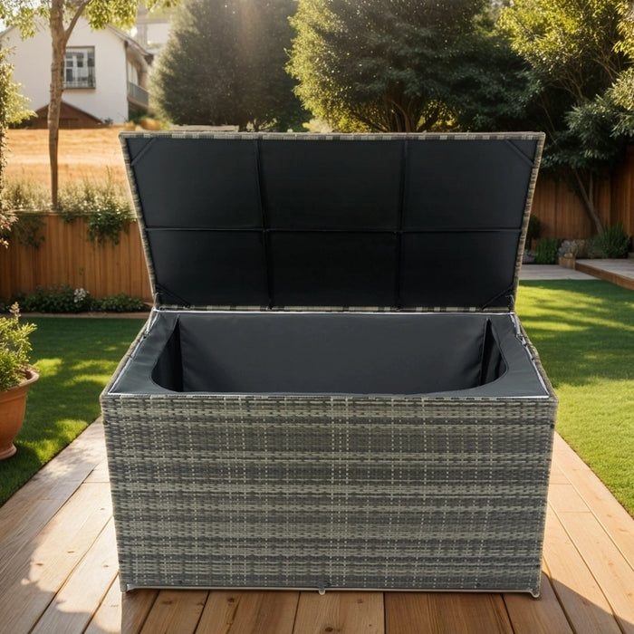Giga outdoor wicker storage box with lid, ideal for patio cushions, kids toys, towels, and pillows in a garden setting.