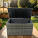 Giga outdoor wicker storage box with lid, ideal for patio cushions, kids toys, towels, and pillows in a garden setting.