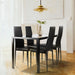 Giga 5-piece dining room set with tempered glass table and four black faux leather chairs in a kitchen or dining area.