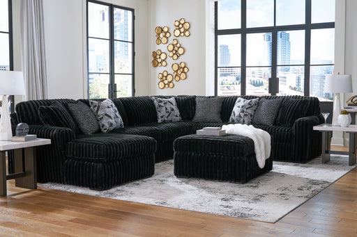 Signature Design by Ashley Midnight-Madness 5-piece living room sectional set with plush cushions and modern fabric upholstery.