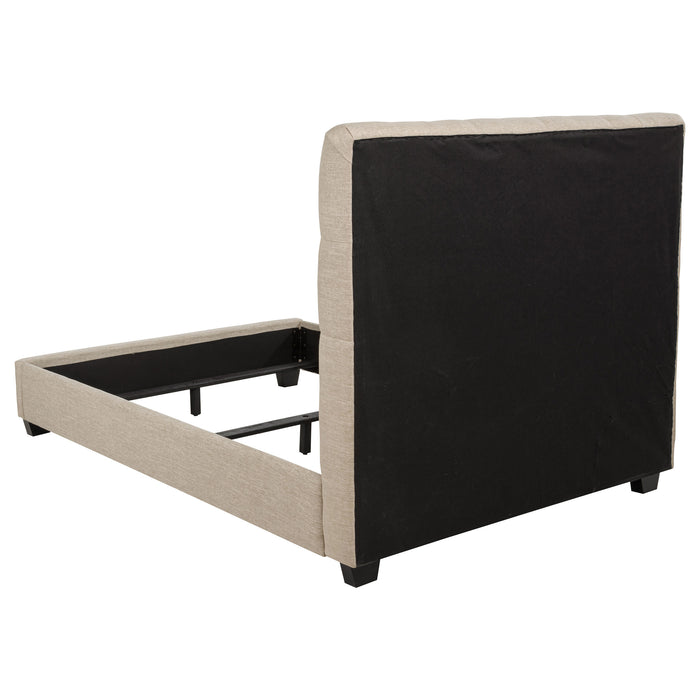 Chloe upholstered full panel bed in oatmeal fabric with a tufted headboard and wooden legs, displayed in a bedroom setting.