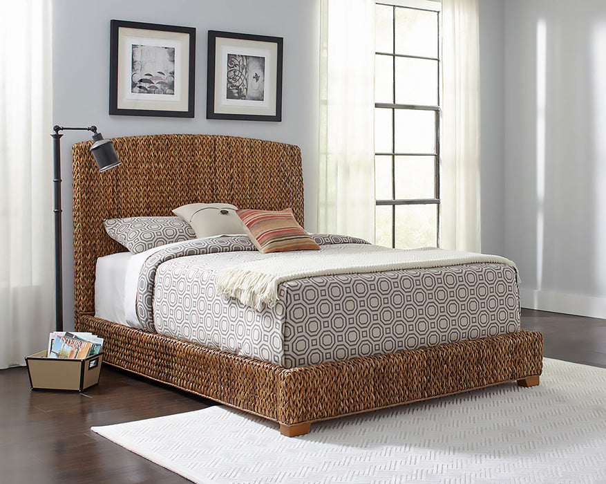 CoasterEssence Laughton Banana Leaf Queen Panel Bed in amber wood with detailed carved headboard and classic furniture style.