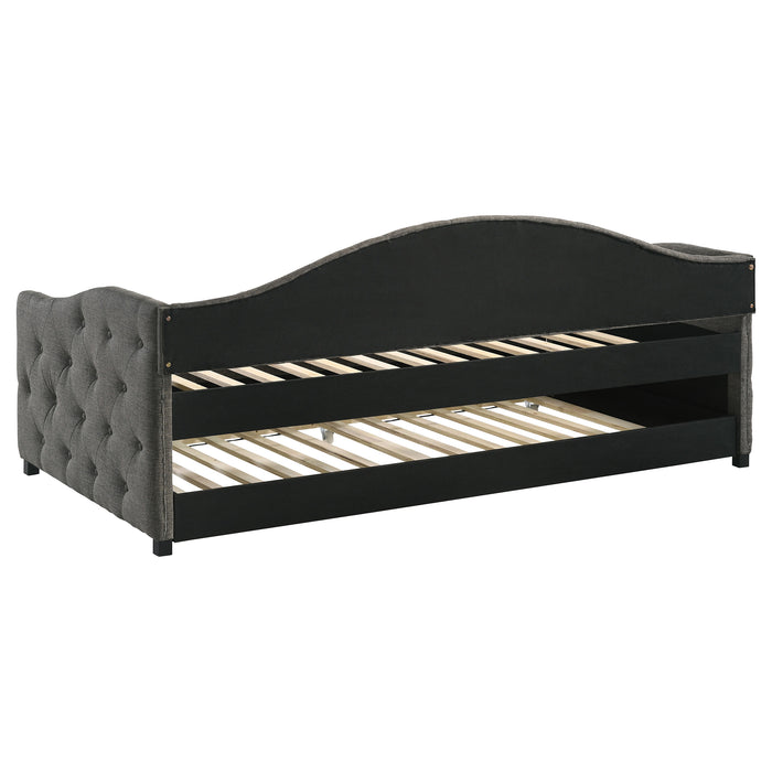 Grey Sadie upholstered twin daybed with trundle and storage drawers by CoasterEveryday, shown with plush fabric and wooden legs.