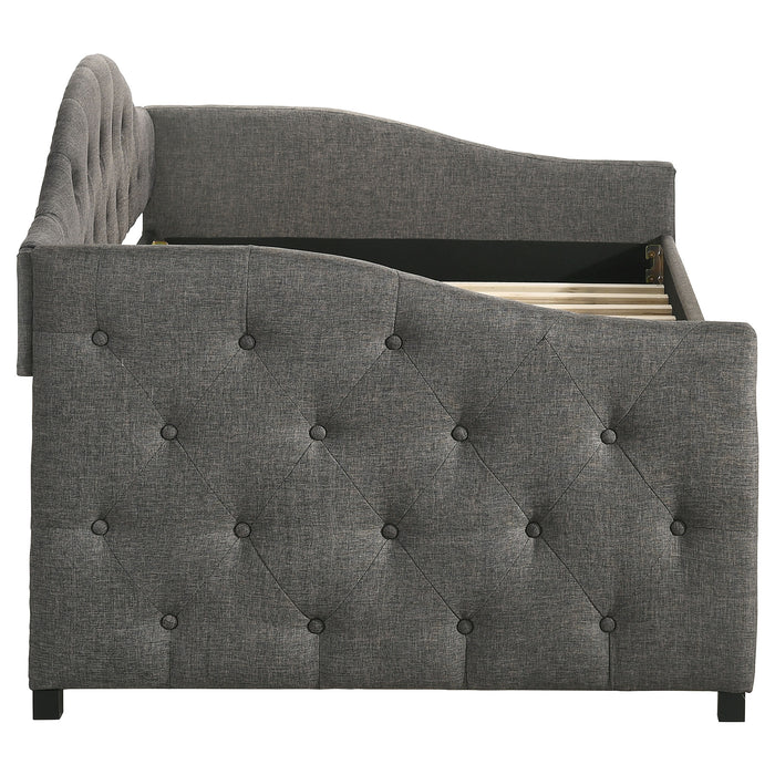 Grey Sadie upholstered twin daybed with trundle and modern design, featuring plush fabric and wooden legs for versatile bedroom decor.