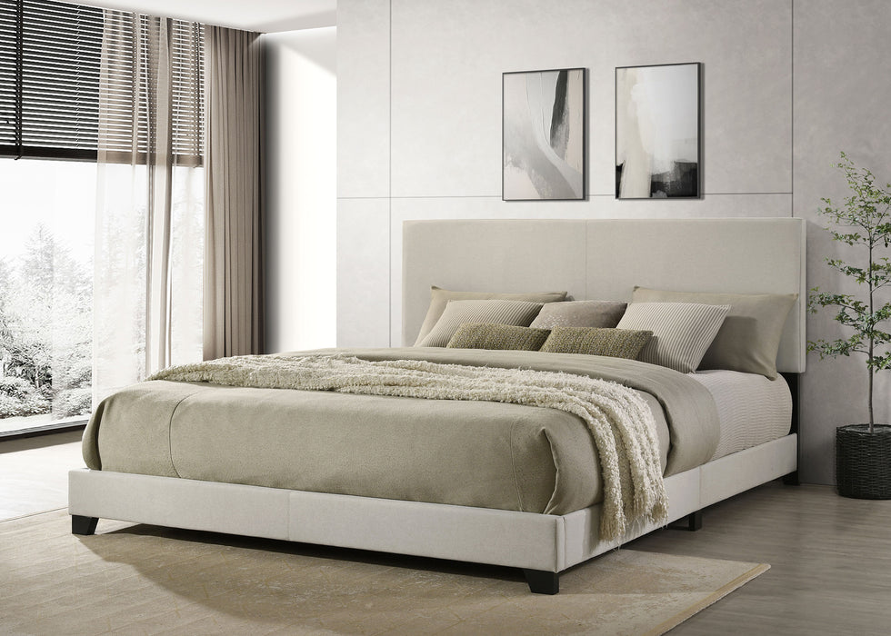 Cream fabric upholstered California King panel bed by CoasterEveryday with a modern, upholstered headboard and sleek wooden frame.