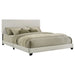 Cream fabric upholstered California King panel bed with clean lines and padded headboard for modern bedroom decor.