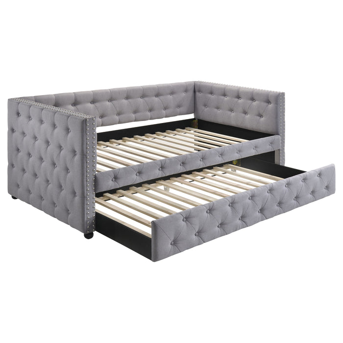 CoasterEssence Mockern upholstered twin daybed with trundle in grey, featuring a padded headboard and sleek wooden frame.
