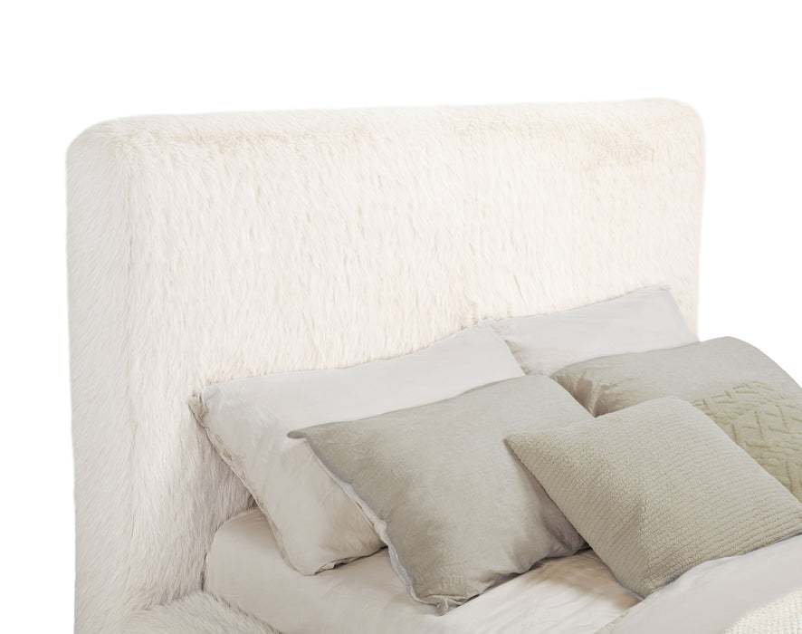 Cream Rebecca faux fur upholstered California King bed with tufted headboard and wooden legs, designed for cozy, luxurious bedroom furniture.