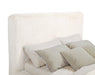 Cream Rebecca faux fur upholstered California King bed with tufted headboard and wooden legs, designed for cozy, luxurious bedroom furniture.