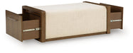 Brown upholstered storage ottoman by Signature Design by Ashley®, featuring a cushioned top and hidden storage space.