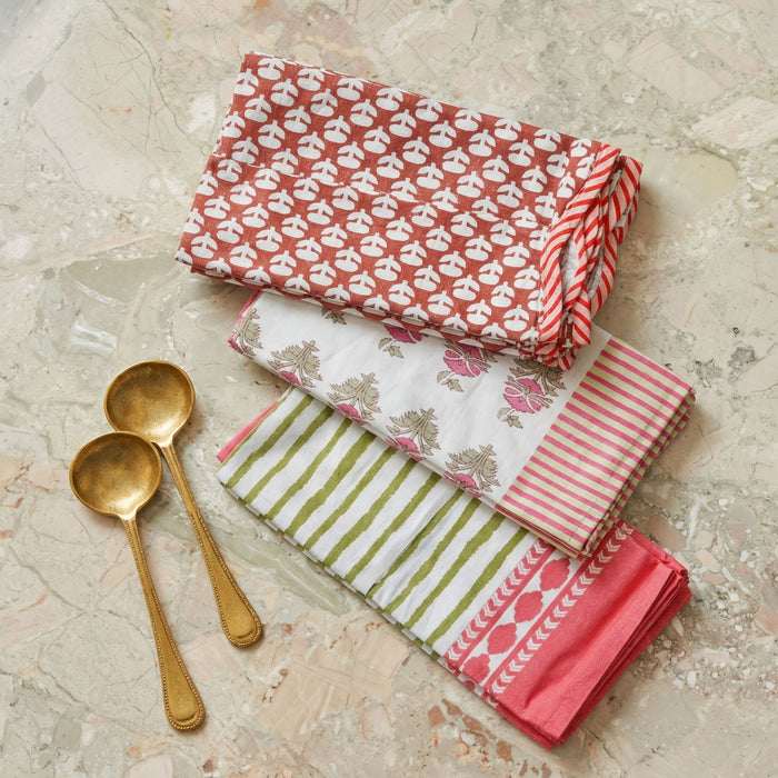 Set of four TOV Furniture Crissy bamboo cotton canvas printed napkins in pink with floral designs, ideal for table setting and decor.