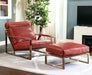 Red top grain leather lounge chair with gold accents and matching ottoman by HomeRoots, featuring a stylish stationary design.