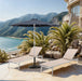 Aluminum patio umbrella by Meridian Furniture with a round black and white base, ideal for outdoor shade and sun protection.