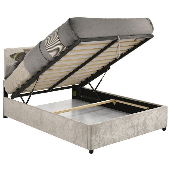 Beige Reeves upholstered full lift-top storage platform bed with padded headboard and wooden frame, featuring clean, modern furniture design.
